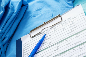 A clipboard and a pen on medical uniform