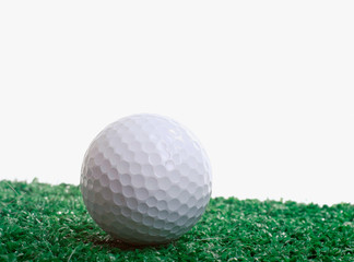 Golf ball on green grass background