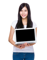 Woman show with blank screen of laptop computer
