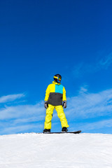 Fototapeta na wymiar Snowboarder sliding down the hill, snow mountains