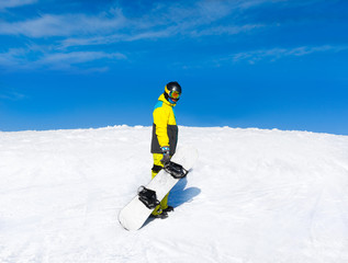 Fototapeta na wymiar Snowboarder hold snowboard on top of hill