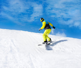 Fototapeta na wymiar Snowboarder sliding down the hill, snow mountains