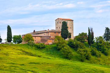 Fototapeta na wymiar Big stone farmer house on green hill, Tuscany, Italy