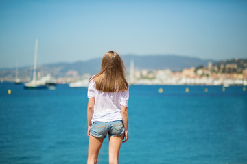 Fototapeta na wymiar Beautiful young girl on the beach in Cannes