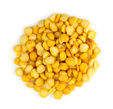 Closeup of heap of yellow chana split peas isolated against whit