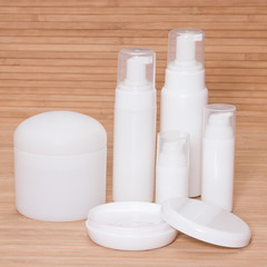 Obraz na płótnie Canvas Open jar of cream and other body care cosmetics