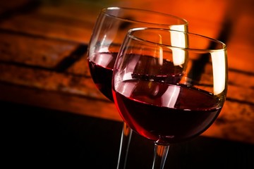 red wine glasses on wood table with warm atmosphere background