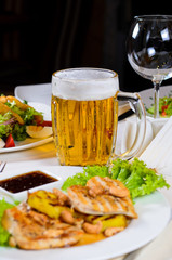 Mug of Beer Amidst Plated Dishes on Table