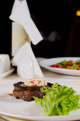 Plated Meal of Steak Topped with Herbed Butter