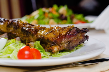 Rack of Grilled Pork Ribs on Plate in Restaurant