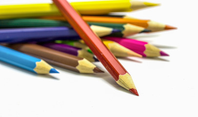 Fototapeta premium Close up of color pencils with different color over white backgr