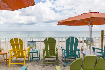 Colorful wooden chairs on the beach in Vero Beach.