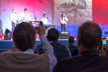 people making video record of the concert