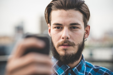 Fototapeta premium young handsome bearded hipster man selfie