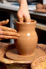 hands of a potter, creating an earthen jar