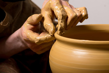 hands of a potter, creating an earthen jar