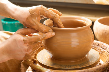 hands of a potter, creating an earthen jar