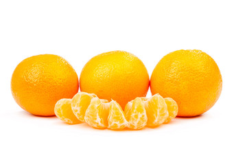 three tangerines and a few slices isolated