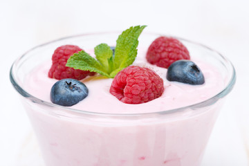 fruit yogurt with raspberry and blueberry, close-up