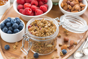 glass jar with homemade granola and berries