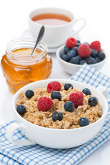 oat porridge with berries and honey, a cup of black tea