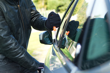 Thief stealing a car