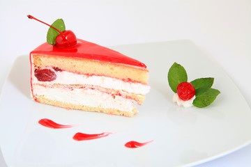slice of fresh cherries cake with a fresh cherry on top