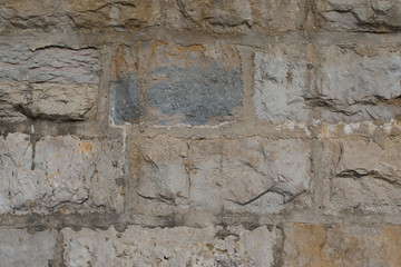Natural stones are folded in wall. Background.