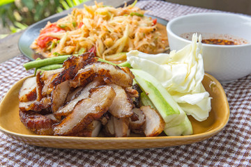 Closeup Thai papaya, charcoal-boiled pork neck,Grill pork (popular food Thailand)