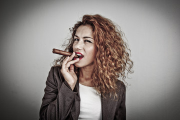 Closeup portrait of a young businesswoman smoking cigar