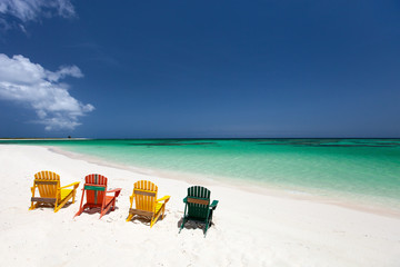 Colorful chairs on Caribbean beach