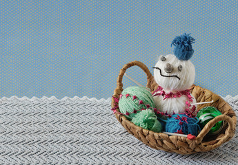 Snowman in the basket with balls of yarn