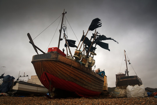 Fishing boats on a beach in Hastings harbour, East Sussex, UK.