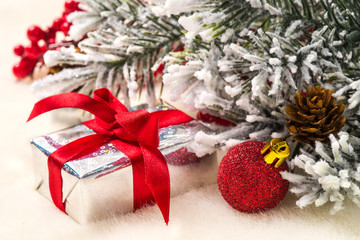 Christmas gifts and decorations on the background of fir branche