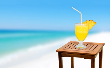 Glass of Fresh Pineapple Juice On A Table Near The Beach