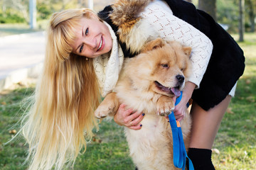 Attractive girl with her dog wearing warm clothes