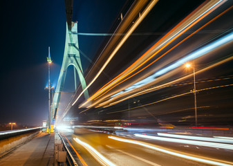 Fototapeta na wymiar the light trails on the Moscow bridge in Kiev at night