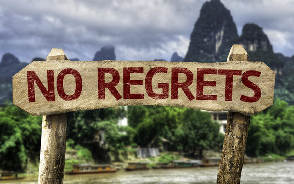 No Regrets sign with a forest background