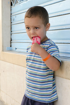 Child With Ice Cream Lolly At Street