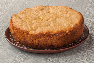 Pie of oat flour on embroidered tablecloth