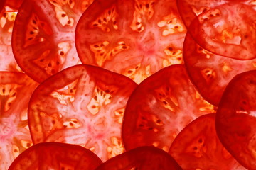 Sliced tomatoes as food background, top view