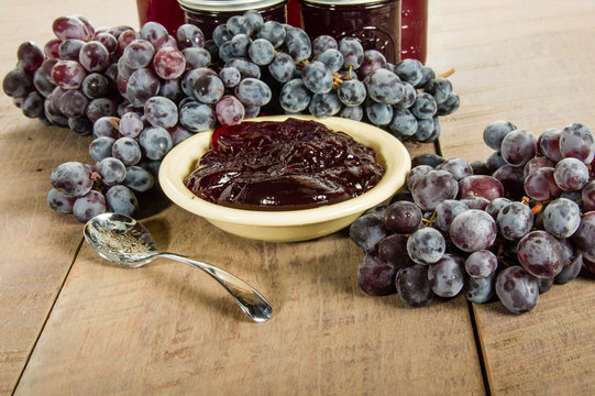 Bowl Of Grape Jelly With Jars