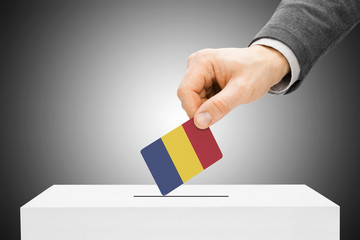 Voting concept - Male inserting flag into ballot box - Chad