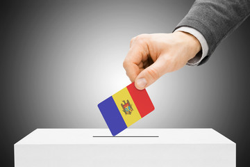 Voting concept - Male inserting flag into ballot box - Moldova