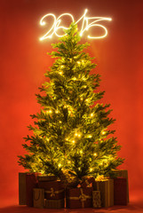 Christmas tree with gifts and 2015 sign on red background full l
