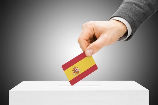 Voting concept - Male inserting flag into ballot box - Spain