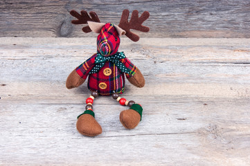 Christmas reindeer toy on wooden background