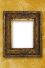 classic old wooden picture frame carved by hand on gold wallpape