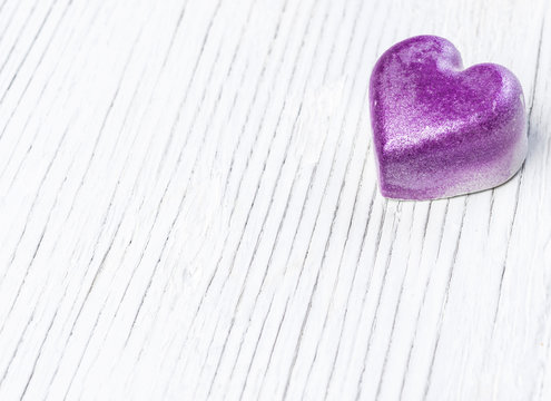 Violet heart on wood. Valentines day background