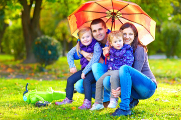 portrait of happy family in autumn park